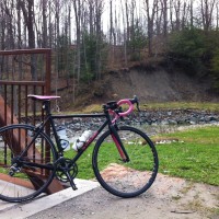 Rain slapped the pavement. Wind blew inland from the lake, whipping flags through soggy seizures, the spray into my eyes. There was no relief in going down. Puddles found fissures in the road to pool and arrest rivulets in no difference between my skin and shiny tarmac. We churned. Reaching the parking lot at the […]