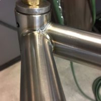 Titanium road bike designed for large tire clearance with long reach caliper brakes.