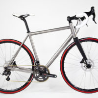 Custom Blend titanium disc road bike. Featuring Campy Record with H11 brakes and cranks along with a Columbus Futura fork, internal headset and Enve cockpit.