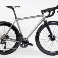 Titanium disc road bike featuring a tapered headtube with IS bearings, flat-mount brakes, Shimano Dura Ace Di2 and Enve cockpit and wheels.